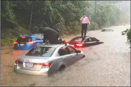  ?? The Associated Press ?? FLOODED COMMUTE: Motorists are stranded on a flooded section of Canal Road in Washington during a heavy rainstorm, Monday.