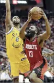  ?? AP photo ?? James Harden of the Rockets is fouled by the Warriors’ Alec Burks during Houston’s 129-112 victory on Wednesday.