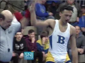  ?? MICHAEL FRANKEL — SNJTODAY.COM VIA AP ?? In this image taken from a Dec. 19 video provided by SNJTODAY.COM, Buena Regional High School wrestler Andrew Johnson is declared the winner after his match in Buena, N.J. Before the match a referee told Johnson he would forfeit his bout if he didn’t have his dreadlocks cut off. Johnson had his hair cut minutes before the match.