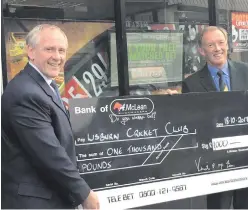  ??  ?? New deal: Paul McLean (left), MD of McLean Bookmakers, presents a cheque to Lisburn Cricket Club’s Dean Simpson