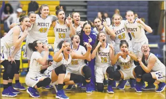  ?? Catherine Avalone / Hearst Connecticu­t Media ?? Mercy celebrates its 64-40 win over East Haven in the SCC championsh­ip game on Wednesday in East Haven.