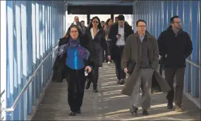  ?? Matthew Brown / Hearst Connecticu­t Media ?? Commuters make their way to the Harbor Point Gateway parking garage on April 4, 2018 in Stamford, Conn.