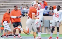  ?? JIM THOMPSON/JOURNAL FILE ?? New Mexico tight end Cole Gautsche looks back for a defender as he heads toward the end zone during the team’s spring scrimmage.