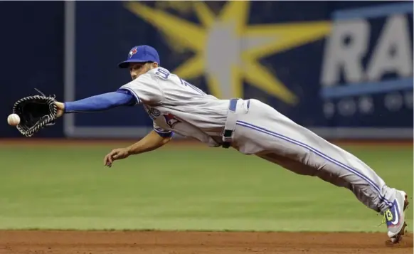  ?? CHRIS O’MEARA/THE ASSOCIATED PRESS ?? Blue Jays first baseman Chris Colabello struggled at the plate but made up for it with his glove, making a diving stop on a ground ball hit by Corey Dickerson during the first inning Sunday.