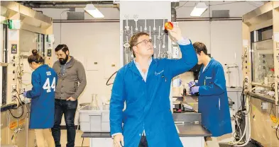  ?? PHOTOS: MATHEW SCOTT / THE NEW YORK TIMES ?? James Rogers inspects fruit at his lab in California. Apeel Sciences has developed a method for creating impercepti­ble, edible barriers that the company says can extend the life of produce by as much as five times.