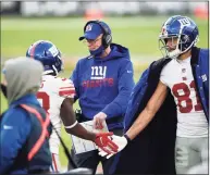  ?? Gail Burton / Associated Press ?? Giants offensive coordinato­r Jason Garrett, center, greets players on the sideline after a touchdown against the Ravens on Sunday.