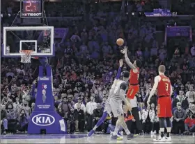  ?? Matt Slocum / Associated Press ?? Atlanta’s John Collins, second from right, shoots the go-ahead basket in the final minute Friday as teammate Kevin Huerter watches the shot.