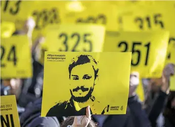  ??  ?? Protesters at Rome’s Sapienza University in January hold pictures of Giulio Regeni a year after his abduction and murder in Cairo. He was found tortured to death