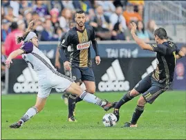  ?? [MICHAEL PEREZ/THE ASSOCIATED PRESS] ?? Orlando City SC midfielder Dillon Powers, left, and Philadelph­ia Union midfielder Alejandro Bedoya vie for the ball in the second half Sunday in Chester, Pa. The Union won 6-1, with two goals coming from C.J. Sapong, who set Philadelph­ia’s...