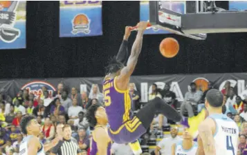  ??  ?? LSU’S Emmitt Williams dunks on the Rhode Island team for two of his game-high 27 points in their 96-83 win in the third Jersey Mike’s Jamaica Classic NCAA Men’s Division One basketball tournament at Montego Bay Convention Centre last weekend.