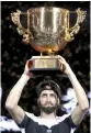  ?? — AFP ?? Nikoloz Basilashvi­li poses with the trophy.