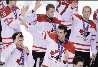  ?? MIKE DREW QMI Agency ?? Team Canada waves to the crowd as they celebrate winning bronze in the World Junior Hockey Championsh­ip at the Scotiabank Saddledome in Calgary on Thursday. Canada defeated Finland 4-0.