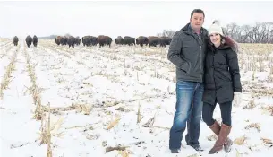 ??  ?? Brooks White, seen with his wife, Jen, says that regenerati­ve farming techniques have allowed them to cut down on the use of chemicals and diesel fuel on their bison farm in Manitoba.