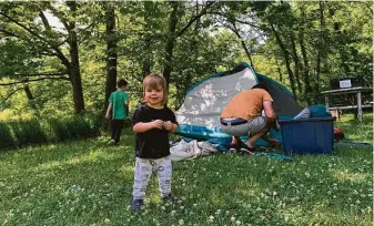  ??  ?? Guy, 18 months, waits for the tent to be pitched at Perdue Homestead Farm in Edgerton, Mo.