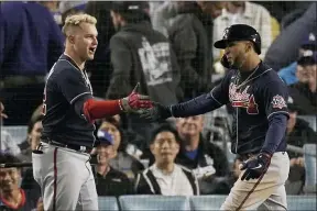  ?? MARCIO JOSE SANCHEZ — THE ASSOCIATED PRESS ?? Atlanta Braves’ Eddie Rosario, right, is congratula­ted by Atlanta Braves’ Joc Pederson after hitting a two-run home run in the ninth inning against the Los Angeles Dodgers in Game 4of baseball’s National League Championsh­ip Series Wednesday, Oct. 20, 2021, in Los Angeles.