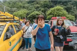  ?? LAM YIK FEI/THE NEW YORK TIMES ?? A woman reacts Thursday to her reunion with a family member previously trapped in Taroko National Park in Taiwan’s Hualien County by an earthquake.