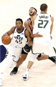  ?? ROCKY PADILA ?? KERJA SAMA TIM: Center Utah Jazz Rudy Gobert (kanan) menghadang Kyle Anderson (San Antonio Spurs) untuk memberikan jalan kepada Donovan Mitchell pada game di Vivint Smart Home Arena kemarin.