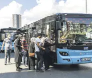  ??  ?? People get on a Turkish-made BMC bus, which is used for public transporta­tion in Istanbul, Sept. 8, 2020.