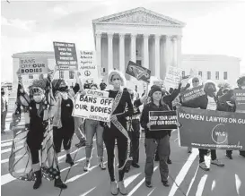  ?? DREW ANGERER/GETTY ?? Abortion rights and anti-abortion activists demonstrat­e Nov. 1 outside the Supreme Court as the justices hear arguments in a challenge to an abortion law.