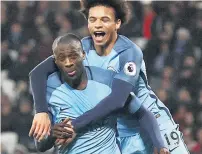  ??  ?? Toure celebrates with youngster Sane