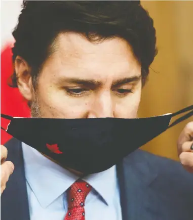  ?? SEAN KILPATRICK / THE CANADIAN PRESS ?? Prime Minister Justin Trudeau implored Canadians to help “flatten the curve” on the rising number of coronaviru­s infections during an update Friday in Ottawa.