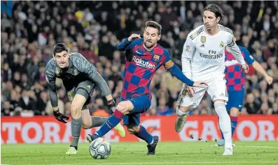  ?? Picture: ALEX CAPARROS/ GETTY IMAGES ?? BACK TO ACTION: Lionel Messi of Barcelona holds off Sergio Ramos of Real Madrid during a match. La Liga matches will return this week.