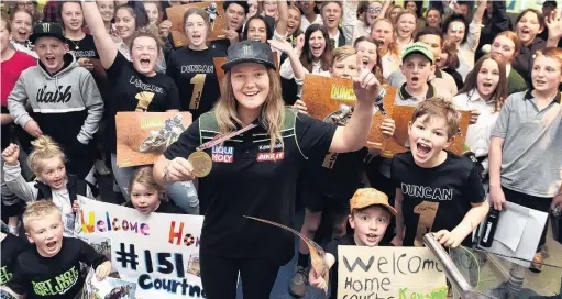  ?? PHOTO PETER MCINTOSH ?? No 1 . . . Women’s motocross world champion Courtney Duncan celebrates with her fans at Dunedin Airport yesterday evening.