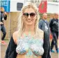  ??  ?? Woman shows off body paint and glitter at Glastonbur­y