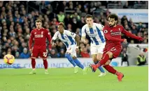  ?? GETTY IMAGES ?? Mohamed Salah scores Liverpool’s winner from the penalty spot against Brighton.