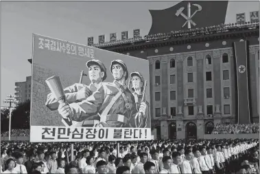  ?? JON CHOL JIN/AP PHOTO ?? Tens of thousands of North Koreans gathered for a rally Wednesday at Kim Il Sung Square in Pyongyang, carrying placards and propaganda slogans as a show of support for their rejection of the United Nations’ latest round of sanctions.