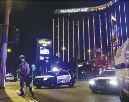  ?? AP PHOTO ?? Police are shown along the Las Vegas Strip near the Mandalay Bay resort and casino Oct. 1 during a shooting at a country music festival.