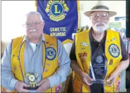  ?? Photo by Susan Holland ?? Bill Mattler, secretary of the Gravette Lions Club (left), and Jeff Davis, president of the club, attended the state Lions convention in Hope on April 28-29. Mattler is holding the Centennial Legacy Project award received for the club’s mural in the...