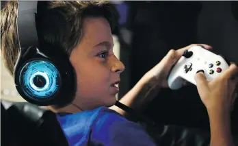  ?? MARTHA IRVINE/THE ASSOCIATED PRESS ?? Henry Hailey, 10, plays the online game Fortnite in the basement of his Chicago home. His parents are on a mission to limit screen time for Henry and his 15-year-old brother.