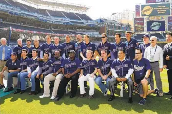  ?? LENNY IGNELZI AP ?? Members of the Padres 1998 World Series team pose for a photo during pregame activities for a baseball game between the Diamondbac­ks and the Padres at Petco Park in June 2014. Front and center is Tony Gwynn.