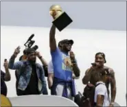  ?? TONY DEJAK — THE ASSOCIATED PRESS ?? Cleveland Cavaliers’ LeBron James holds up the Larry O’Brien Trophy after arriving in Cleveland on Monday. James came home with the trophy he promised, and the championsh­ip Cleveland has coveted for 52 years.