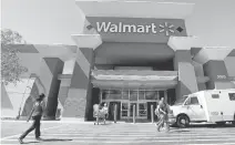  ?? JEFF CHIU/ASSOCIATED PRESS ARCHIVES ?? Wal-Mart Stores says it will hire 10,000 workers and support 24,000 more constructi­on jobs with store openings and expansions.