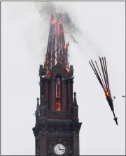  ?? (AP/The Baltimore Sun/Barbara Haddock Taylor) ?? Part of the steeple falls from the Urban Bible Fellowship Church in Baltimore during a fire on Saturday. The city’s Fire Department said no injuries were reported in the blaze at the nearly 200-year-old church.