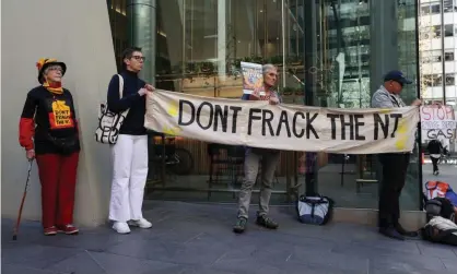  ?? Photograph: Loren Elliott/Reuters ?? Environmen­tal and First Nations activists protest proposed fracking plans in the Northern Territory’s Beetaloo Basin, outside the Sydney offices of Empire Energy in May. Imperial Oil and Gas, a subsidiary of Empire Energy, has received $21m in grants from the federal government.