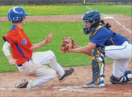  ?? PHOTOS BY KYLE MENNIG — ONEIDA DAILY DISPATCH ?? Oneida’s Tanner Williams, left, slides into home plate where he is tagged out by Cazenovia catcher Evan Begley during the top of the fourth inning of their game in Cazenovia on Saturday.