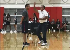  ?? DOUG FEINBERG — THE ASSOCIATED PRESS ?? Connecticu­t head coach Geno Auriemma, right, and Louisville head coach Jeff Walz talk during an Under-23 training camp in Colorado Springs, Colo., Monday. Walz is the head coach of the team. With the start of the college basketball season two months...