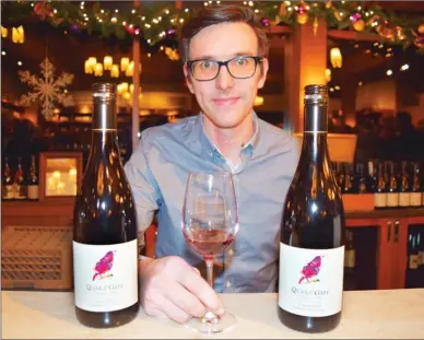  ?? STEVE MacNAULL/The Okanagan Weekend ?? Assistant winemaker Ross Baker shows off the Cailleteau Gamay nouveau ($20) red wine West Kelowna’s Quails’ Gate Winery has just released made of grapes harvested just eight weeks ago.