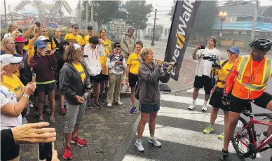  ?? SALLY JENKINS ?? Endurance athlete Diana Nyad rallies her fellow walkers by blowing Reveille before the final leg of their journey.