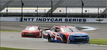  ?? DARRON CUMMINGS — THE ASSOCIATED PRESS ?? Driver Michael Annett leads B.J. McLeod as he maneuvers through a turn during Xfinity Series practice at Indianapol­is Motor Speedway in Indianapol­is on Friday.