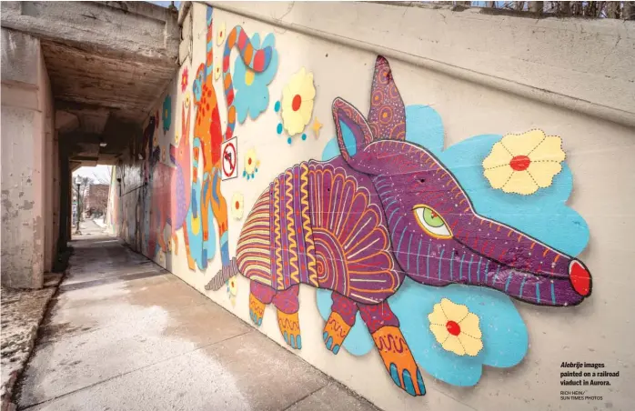  ?? RICH HEIN/ SUN-TIMES PHOTOS ?? Alebrije images painted on a railroad viaduct in Aurora.