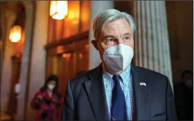  ?? (AP/J. Scott Applewhite) ?? U.S. Sen. Sheldon Whitehouse, D-R.I., leaves the chamber as lawmakers work to advance the $1 trillion bipartisan bill Thursday in Washington.