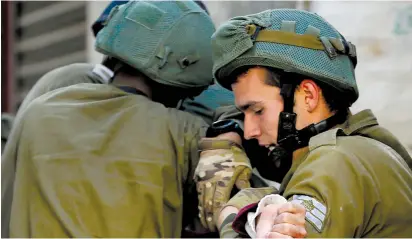  ?? (Mussa Qawasma/Reuters) ?? IDF SOLDIERS detain a Palestinia­n during protests in Hebron yesterday over US President Donald Trump’s declaratio­n last week that Jerusalem is Israel’s capital.