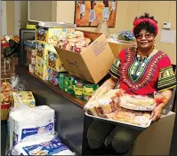  ?? The Sentinel-Record/Richard Rasmussen ?? WEBB CENTER: Mary Moore, Webb Center board president, on Wednesday displays some of the food they will be preparing for Christmas dinners to be given out from noon to 2 p.m. Friday at the center, located at 127 Pleasant St. Moore said they will have enough food for 300 people.