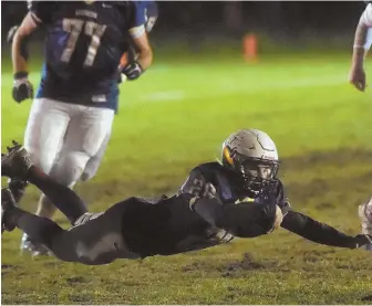  ?? HERALD PHOTOS BY JIM MICHAUD (ABOVE)/ NICOLAUS CZARNECKI (RIGHT) ?? TAKING FULL ADVANTAGE: Lexington’s Ben Quint, shown diving for extra yardage (above) and fighting through a tackle (right), will lead the Minutemen into tomorrow’s game against Burlington. Quint has been starting since his sophomore season.