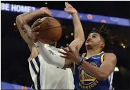  ?? BRANDON DILL — THE ASSOCIATED PRESS ?? Warriors guard Jordan Poole, right, shoots against Grizzlies forward Brandon Clarke during the first half on Tuesday in Memphis, Tenn.