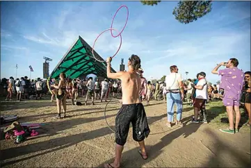  ?? ELIZA GREEN / THE CALIFORNIA­N ?? Festivalgo­er Jeremy Gonzalez juggles hula hoops at the Beacon Stage during this weekend’s music festival at Buena Vista Aquatic Recreation­al Area. See more photos at Bakersfiel­d.com.